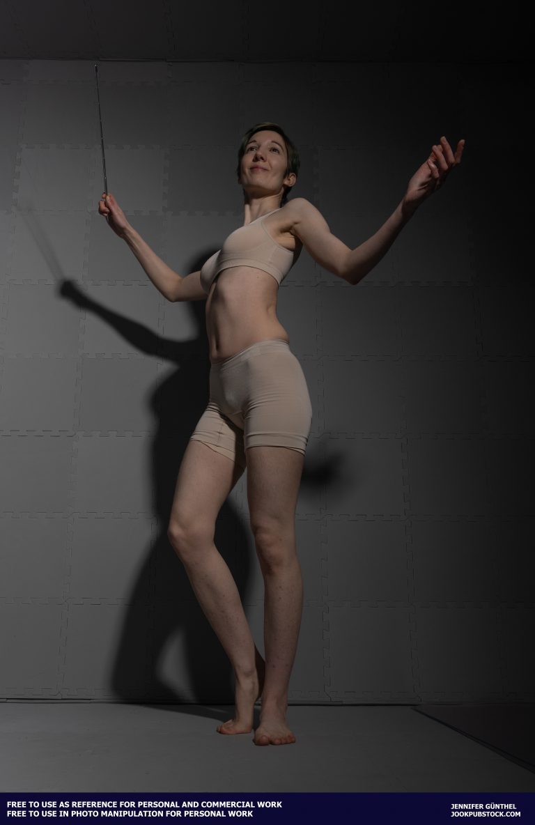 drawing reference photo of a model wearing form fitting underwear, holding a stick