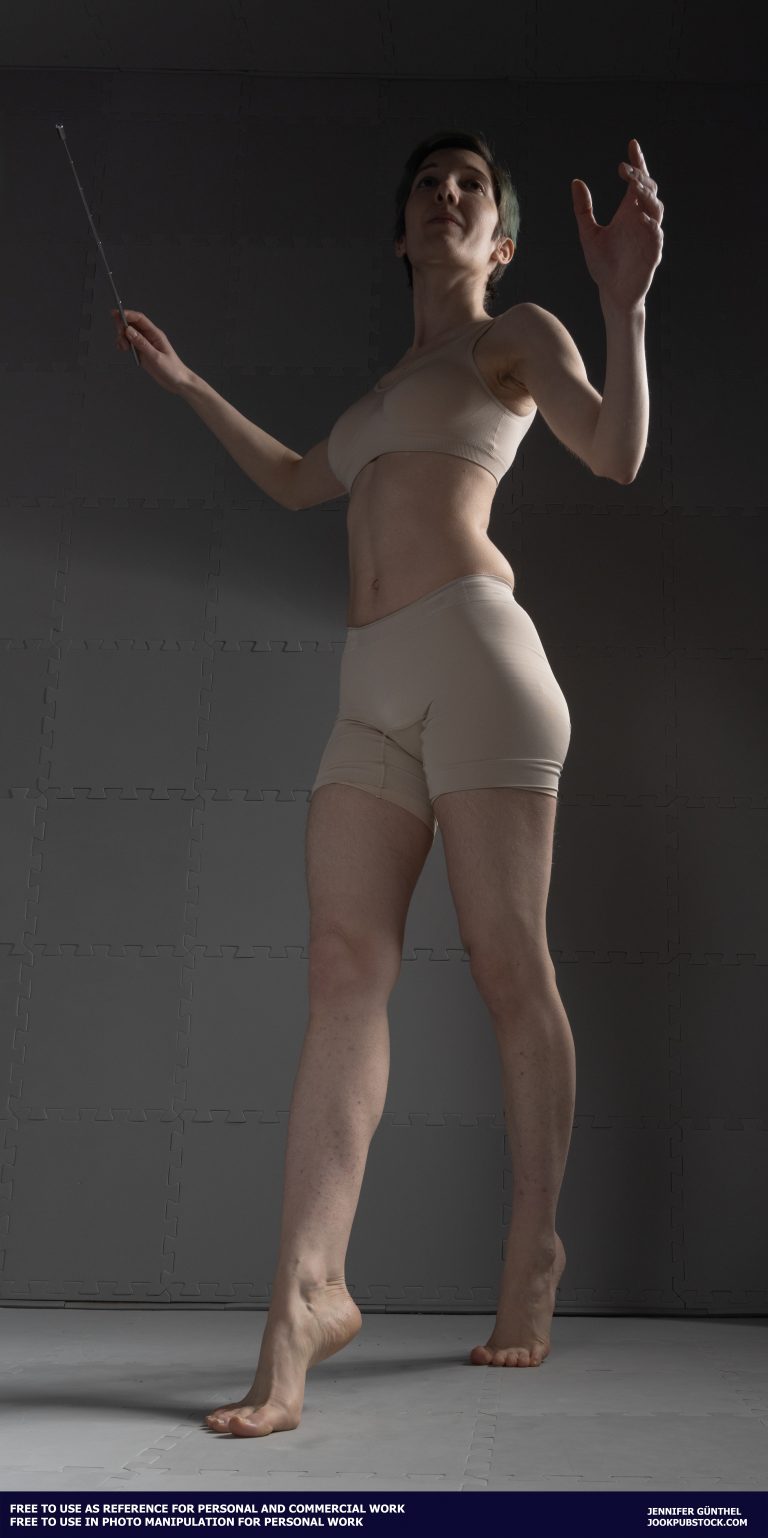 drawing reference photo of a model wearing form fitting underwear, holding a stick