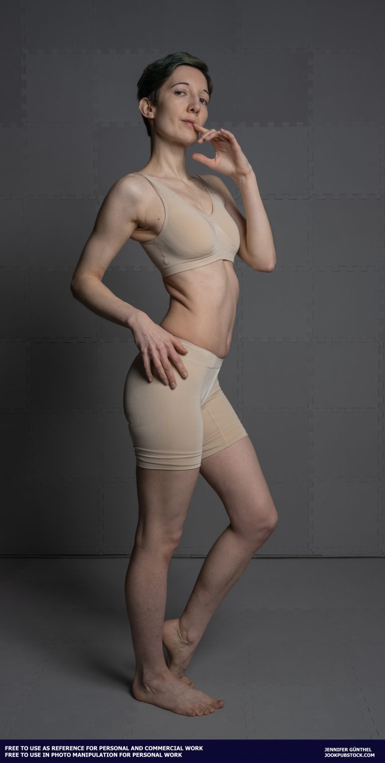 a person in form fitting underwear standing in a sexy pose