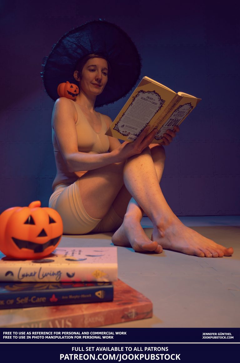 a person wearing a witch hat and reading a book