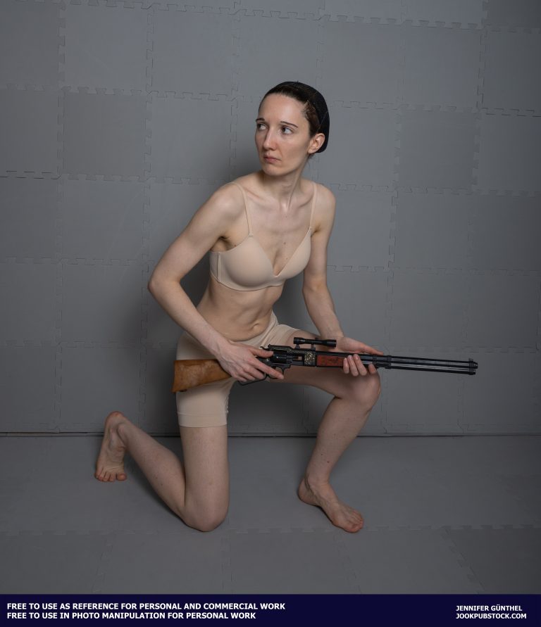 a person kneeling and holding a gun