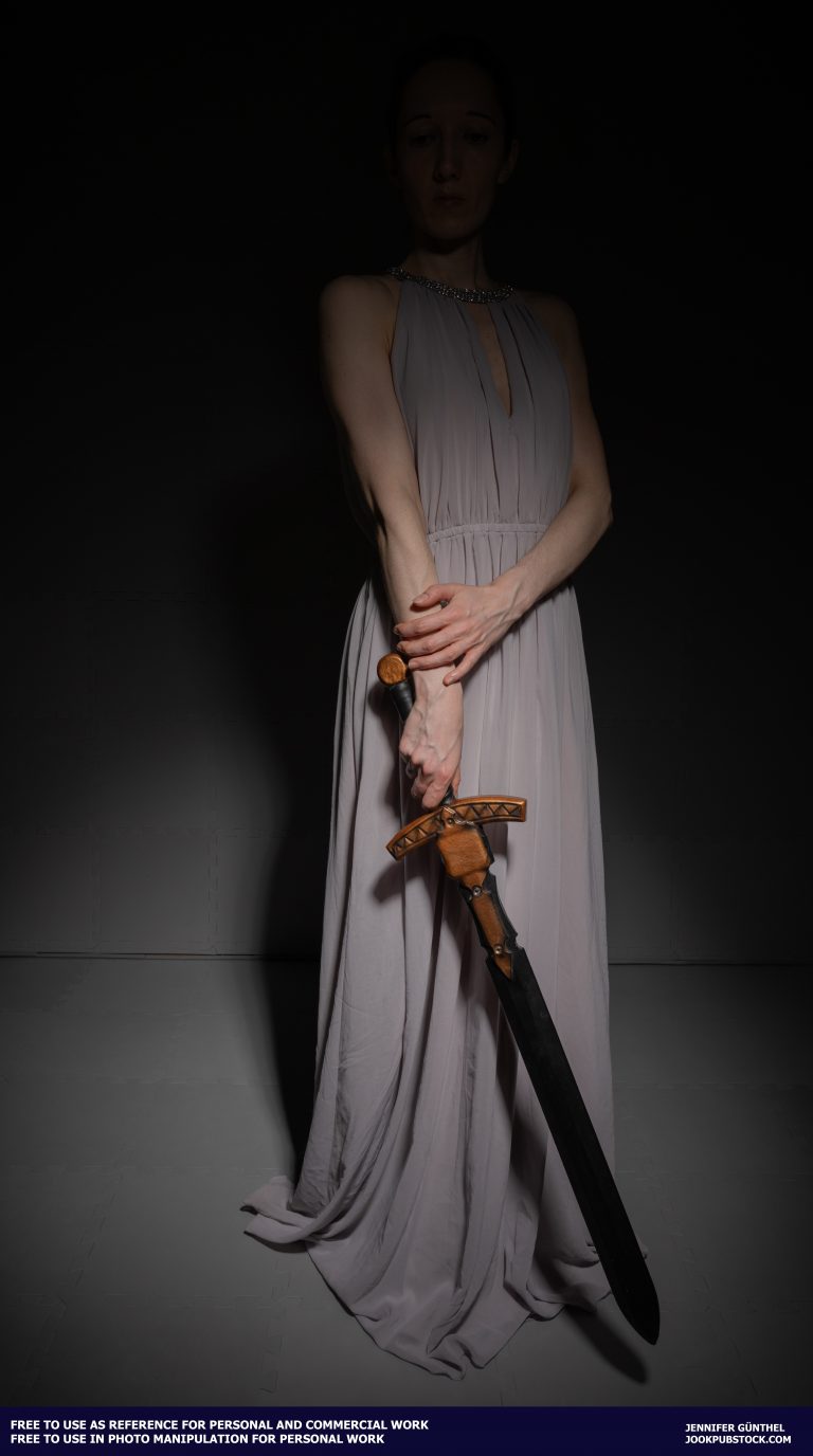 a person wearing a long dress and holding a sword