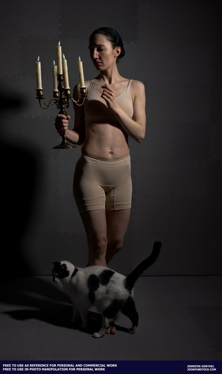 a person in underwear holding a candelabra and a cat is standing in front of them