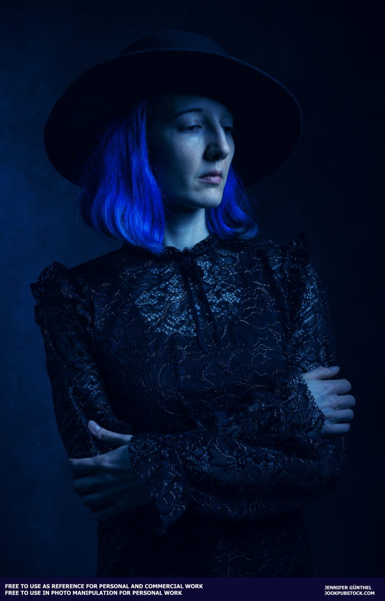 a person with blue hair wearing a black hat