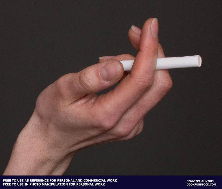a hand holding a cigarette