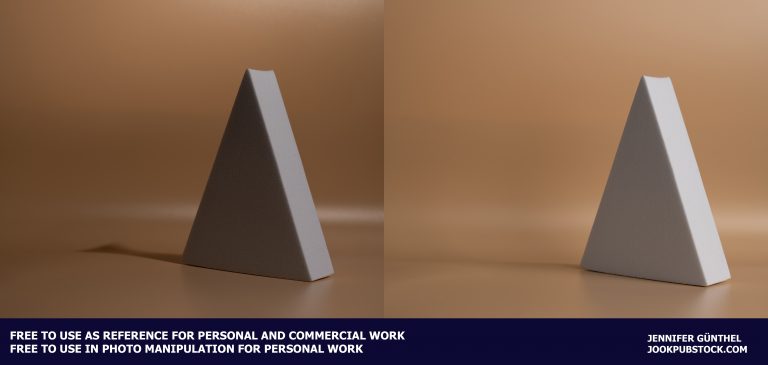 a triangular object on a brown background
