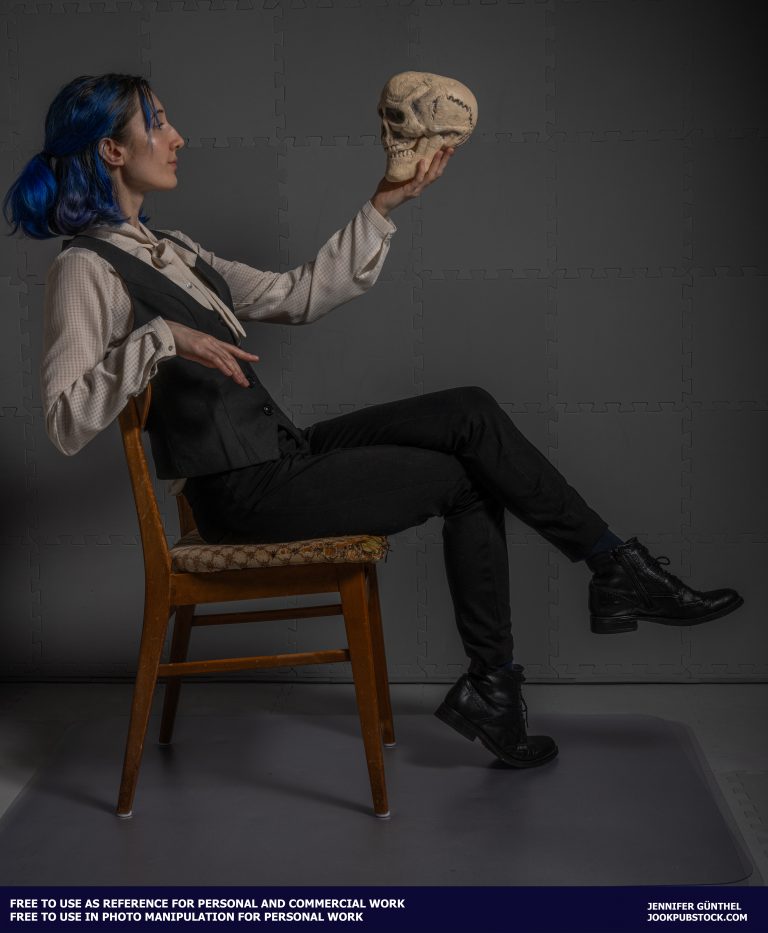 a person sitting on a chair holding a skull