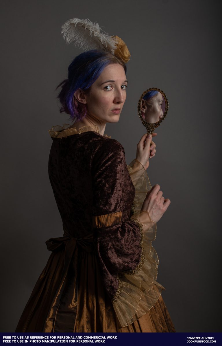 a person wearing a dress and holding a mirror