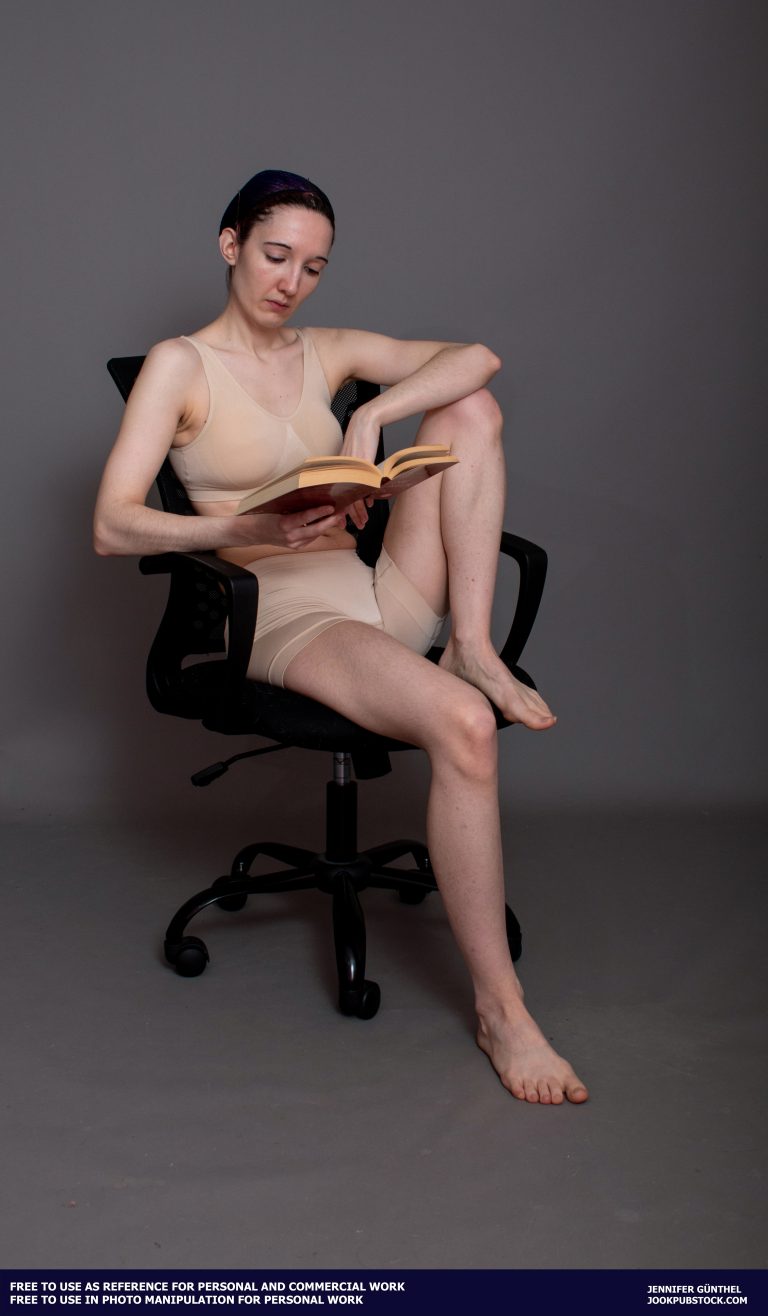 a person sitting in a chair and reading