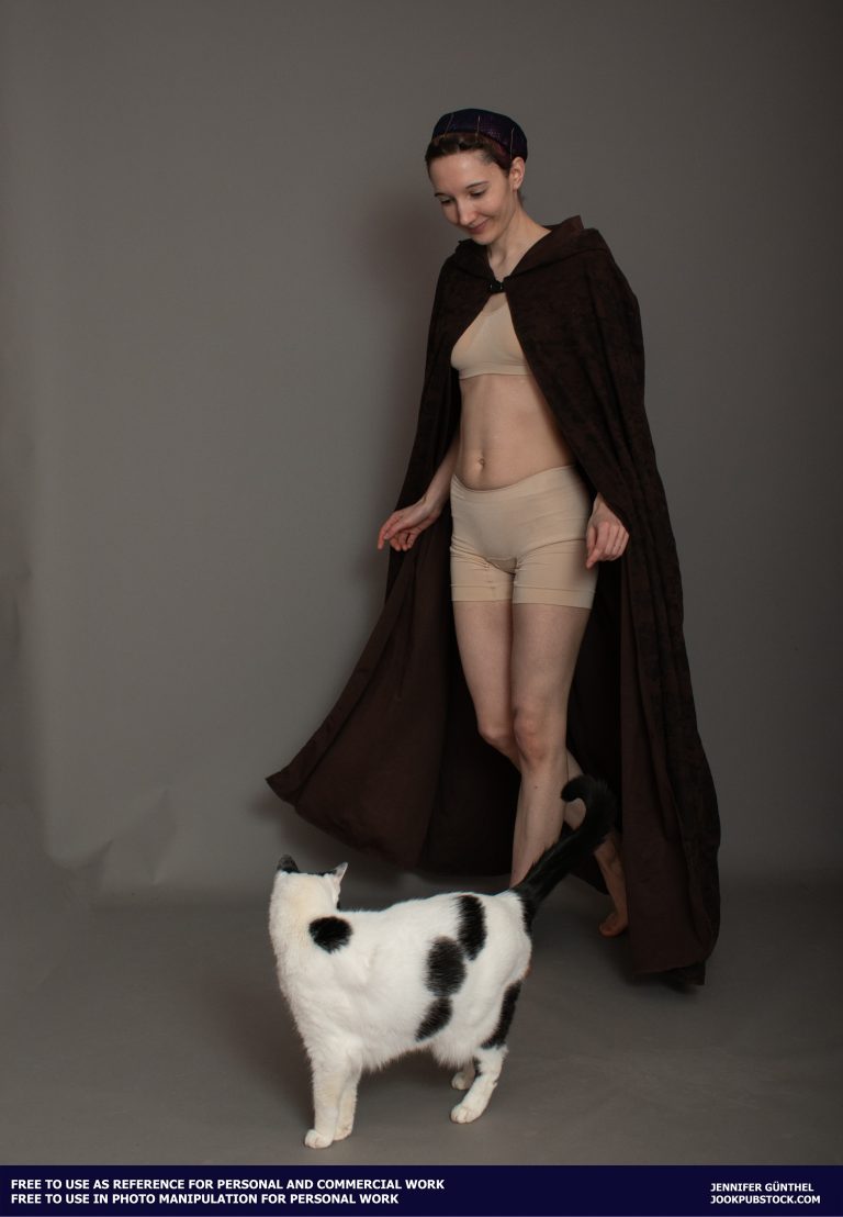 a person wearing a cloak and a cat