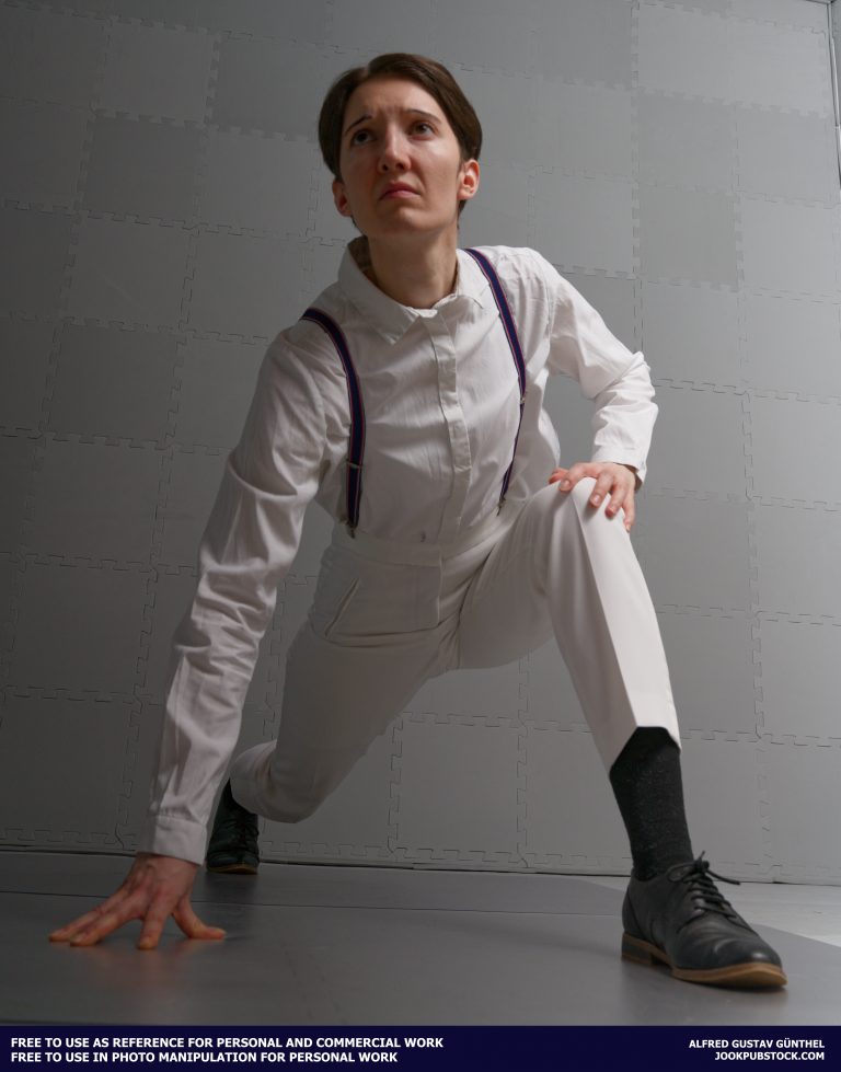 A drawing reference photo of a model wearing a white suit, crouching.
